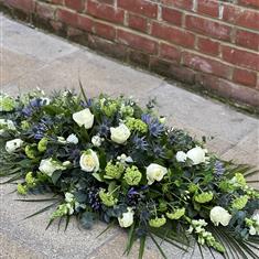 Dainty Blue, White and Green coffin spray