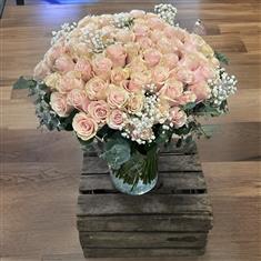 100 Pink Mondial Roses in a vase 